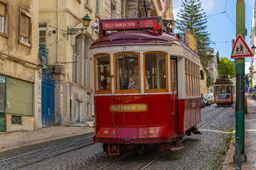 View of vintage red tram on a sunny day in the Alfama District, Lisbon, Portugal, Europe