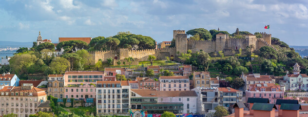 Panoramic view of Lisbon Castle from Miradouro da Senhora do Monte scenic point on a sunny day in the Alfama District, Lisbon, Portugal, Europe