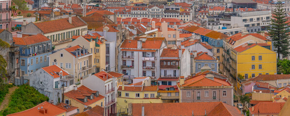 View of rooftops and colourful buildings from Miradouro da Senhora do Monte scenic point on a sunny day in the Alfama District, Lisbon, Portugal, Europe