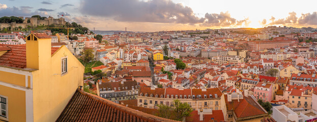Panoramic view of Lisbon Castle from Miradouro da Senhora do Monte scenic point at sunset in the Alfama District, Lisbon, Portugal, Europe