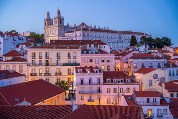 View of colourful buildings and red rooftops at dusk in the Alfama District, Lisbon, Portugal, Europe