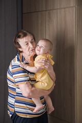 Grandmother Comforting Crying Baby at Home