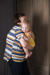 Grandmother Comforting Crying Baby at Home