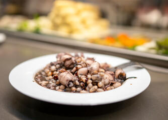 Delicious Pulpo y alubias at food court in Barcelona during spring season