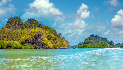 Fototapeta premium Boat ride among stunning karst rock formations and mangrove forests, Langkawi UNESCO Global Geopark, Langkawi, Malaysia