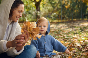 Mother and child enjoying a sunny autumn day outdoors