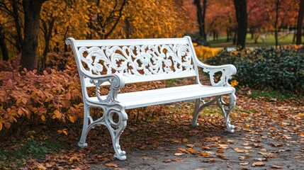 White park bench in autumn leaves