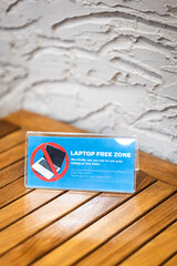 no laptop sign in cafe against remote workers, digital nomad. laptop forbidden in a cafe