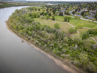 River runs through a forested area with a small town in the background