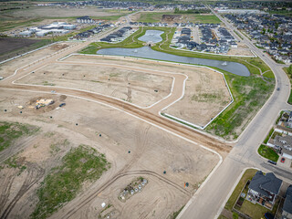View of a residential area with a large empty lot in the middle