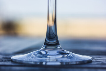 Glass stem: closeup picture with nice stylised reflections, over a golden hour shallow background