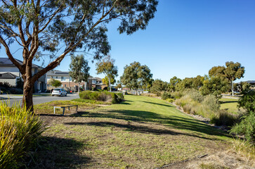A landscaped green buffer zone between residential housing and a natural drainage corridor,...