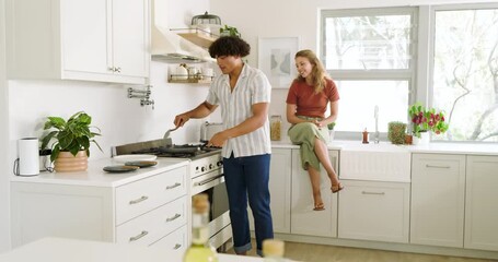 Young diverse couple cooking together in modern kitchen, enjoying quality time at home - Powered by Adobe