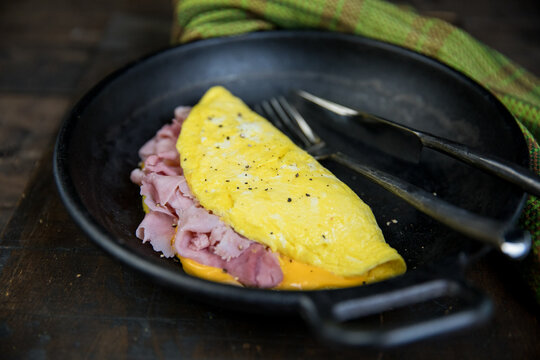 Ham and cheese omelet with coffee toast and fruit 