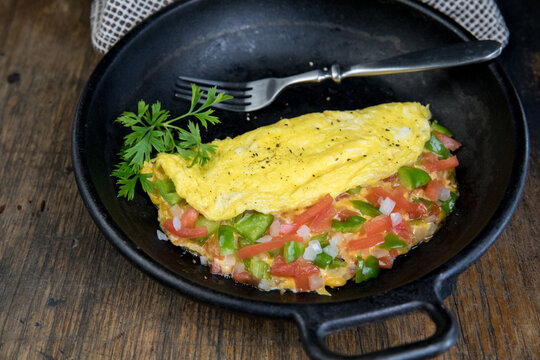 Vegetable and cheese omelet with coffee, toast and fruit 