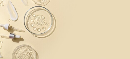 Petri dishes and glass droppers on beige background with space for text, top view