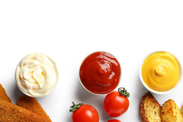 Fototapeta na wymiar Bowls of ketchup, mayonnaise and mustard with snacks isolated on white background