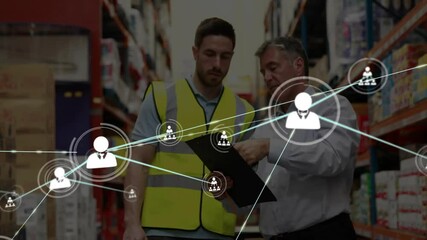 Warehouse supervisor tapping clipboard prompts staff member scanning inventory with network overlay - Powered by Adobe