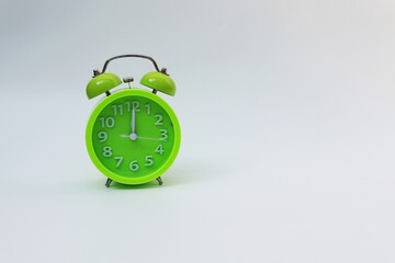 Green alarm clock on white background
