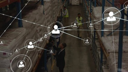 Logistics manager scanning sacks in warehouse activating network icons showing supply chain links - Powered by Adobe