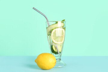 Glass of lemonade with cucumber and mint on blue background