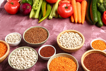 Different fresh vegetables and cereals on purple background