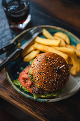 delicious beef burger with fresh vegetables, and sesame bun, served with golden fries, ideal for food and restaurant visuals