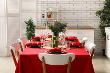 Stylish table setting for Christmas dinner in kitchen