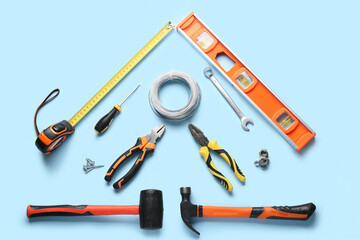 Wires and construction tools on blue background
