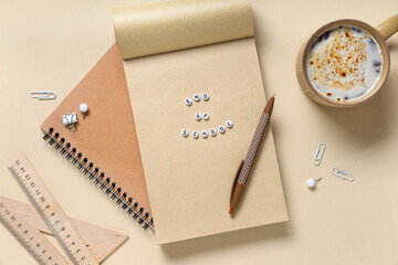 Composition with stationery, text END OF SCHOOL and cup of coffee on color background