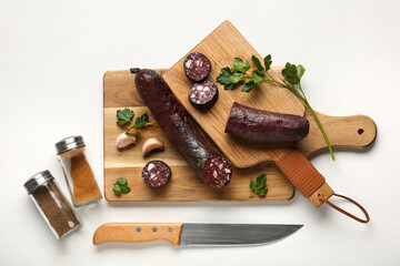Composition with tasty blood sausage on white background, top view