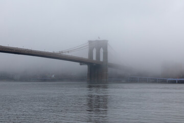View of Brooklyn Bridge as fog covers the city