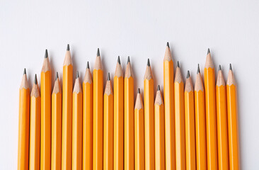 Sharp graphite pencils on light background, flat lay