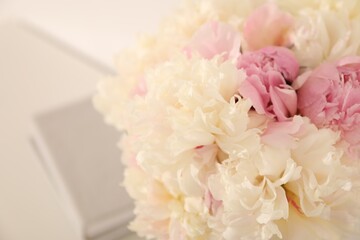 Bouquet of beautiful peonies on blurred background, closeup