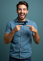 Portrait Cheerful Man Holds Credit Card in Blue Denim Shirt Smiling