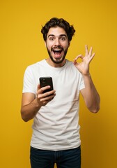 Portrait Man Holding Phone Showing Okay Gesture on Yellow Background