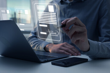 Man signing electronic document with stylus pen on virtual screen above laptop, closeup