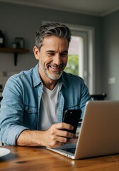 Portrait Man with Phone Smiles While Using Laptop Indoors
