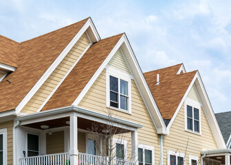 Upper facades of charming family home with composite roofing and balcony in Brighton,...