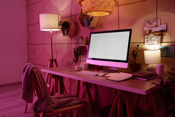 Interior of dark office with workplace, shelves and glowing lamps