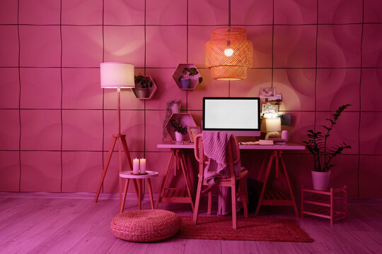 Interior of dark office with workplace, shelves and glowing lamps - Powered by Adobe
