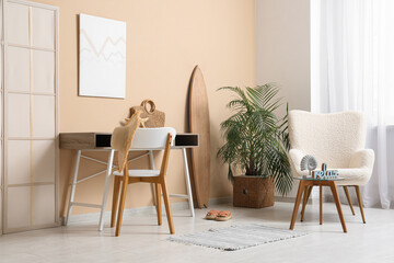 Interior of stylish living room with white armchair, workspace and summer decor