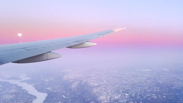 View from the airplane at a rising sun, colorful pink sunrise. 