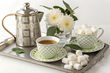Ornate Silver Teapot with Matching Cups on Elegant Tray – Cozy Tea Setting
