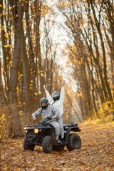 Man and woman driving quad bike in autumn forest © prostooleh