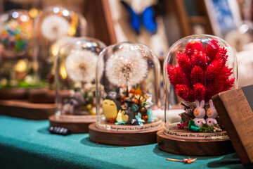 Enchanting Glass Domes Featuring Whimsical Floral Arrangements and Adorable Figurines