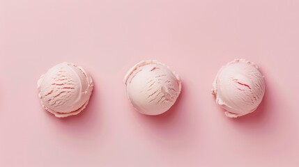 Three scoops of light pink ice cream arranged in a row on a matching pink background in a flat lay style