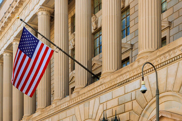 American flag flutters against backdrop of elegant columns architectural details on Washington D.C