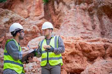 Expert geologists are analyzing layers of rocks that have been deposited for a long time to learn about past organisms and plants.