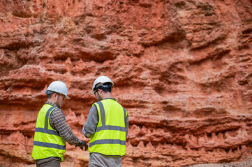 Expert geologists are analyzing layers of rocks that have been deposited for a long time to learn about past organisms and plants.